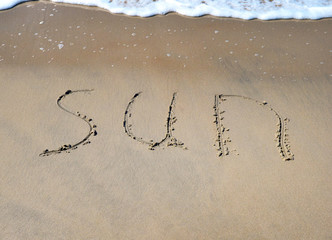 The word sun on the beach background