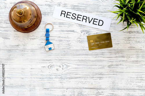 book hotel word reserved near hotel service bell on light wooden hotel word