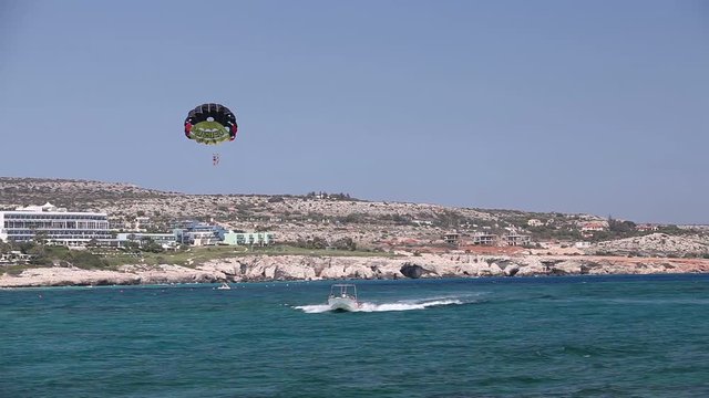 The boat rolls a man on a parachute, Sea entertainment, beautiful coast, good weather