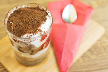 Chocolate mousse in a glass n a wooden background. Beautifully served dessert at the restaurant.