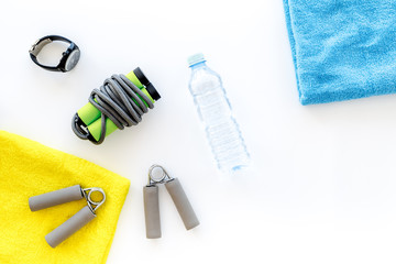 Equipment for fitness. Jump rope and expander on white background top view copyspace