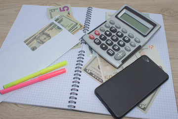 Calculator and money thai banknote on wooden table. The concept of financial planning, savings