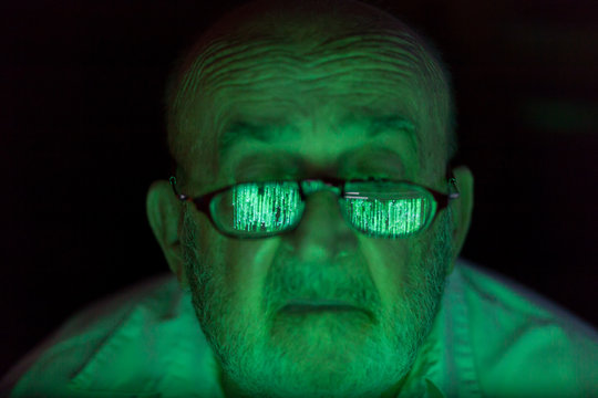 Old Man Looking At A Hacked Computer Screen