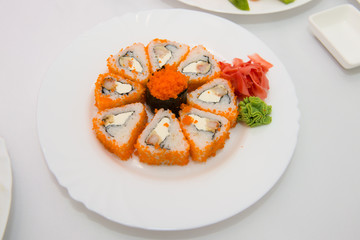 Sushi Set sashimi and sushi rolls served on stone slate. Sushi