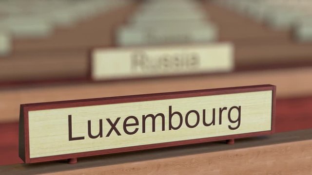 Luxembourg name sign among different countries plaques at international organization. 3D rendering