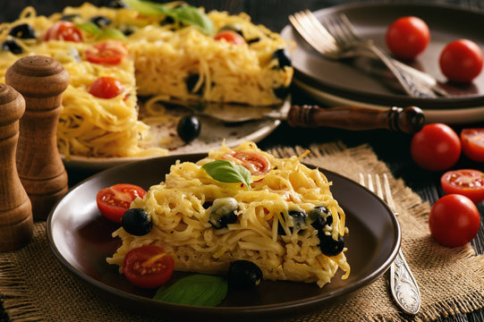 Pasta casserole with tomatoes, olives and cheese.