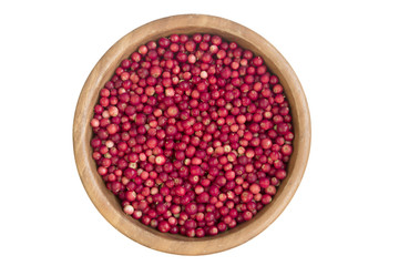 Wooden bowl with fresh cowberry. top view isolated.