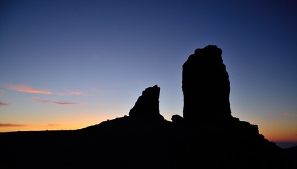 Roque Nublo and the frog backlit with intense blue sky at sunset, Gran canaria island