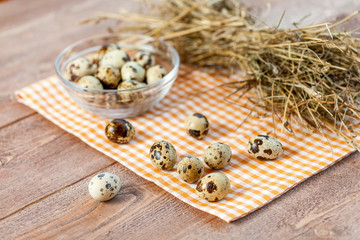 Quail eggs on the old rustic wooden table.