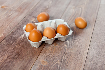 Close-up view of raw chicken eggs on wooden background