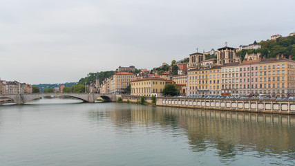 Fototapeta na wymiar Vieux-Lyon, colorful houses and Bonaparte bridge in the center, on the river Saone 