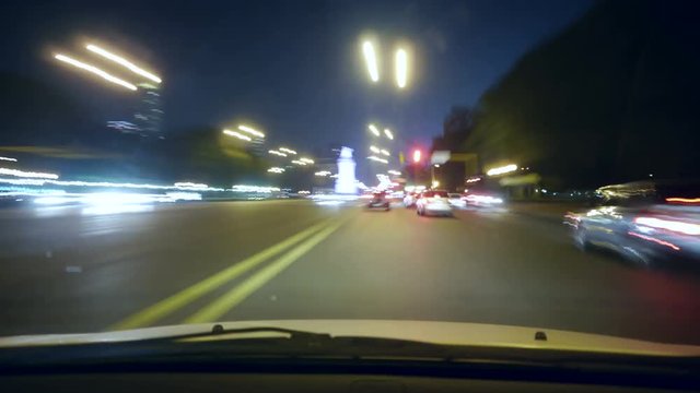 4k - Driving a car time-lapse. POV - point of view. Night, Camera in the front, windshield reference. City, blurred motion, fast driving. Hyperlapse
