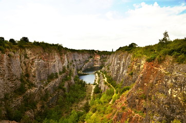 A view of a flooded quarry during a sunny day