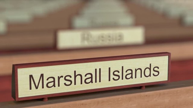 Marshall Islands name sign among different countries plaques at international organization. 3D rendering