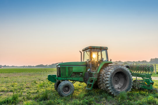 Fototapeta Tractor in a field on a Maryland Farm near sunset