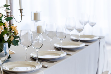 Wedding decorated table. Luxury light decor on table in restaurant