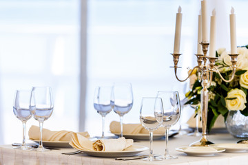 Wedding decorated table. Luxury light decor on table in restaurant