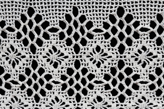 Old napkin embroidery of white thread handmade on a dark background in vintage retro antique style