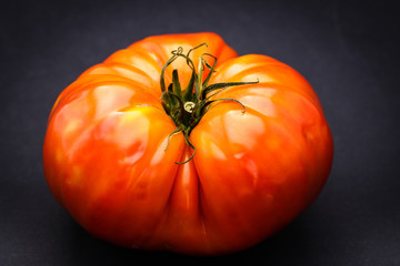 Fresh Ripe Heirloom Tomato Isolated On Black