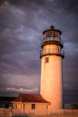 New England Lighthouse at dusk with dramatic sky