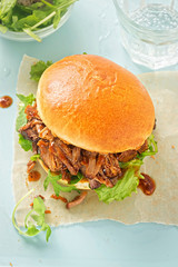 Pulled pork sweet bun with mixed lettuce leaves