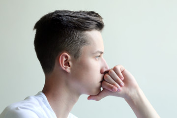 Fototapeta premium Thoughtful and looking young man with hand