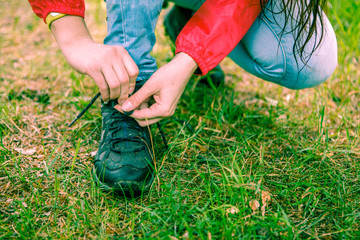Fototapeta na wymiar Photo of woman tying shoelaces