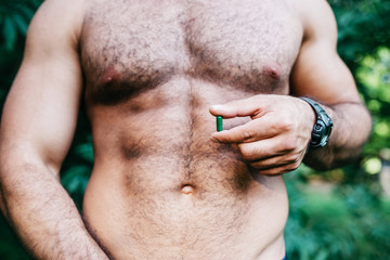 Naklejka premium man showing holding pack of pills