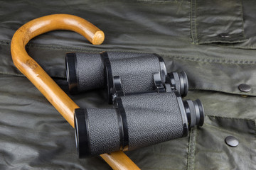 Walking Stick and Binoculars on an Outdoor Coat