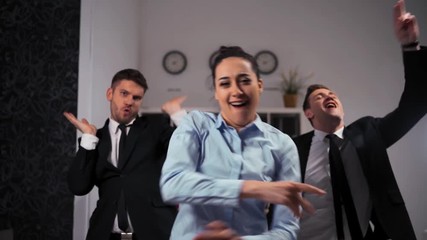 Three joyful businesspeople businesswoman and two businesman dancing cheerfully in office. We happy of friday ending! in 4k Ultra hd resolution. - Powered by Adobe