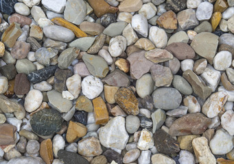 small multi color pebbles stones background