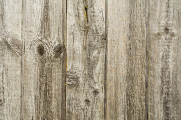 Dark texture of old natural wood with cracks from exposure to sun and wind