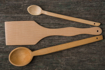 Handmade wooden spoons on a wooden board, kitchen tools