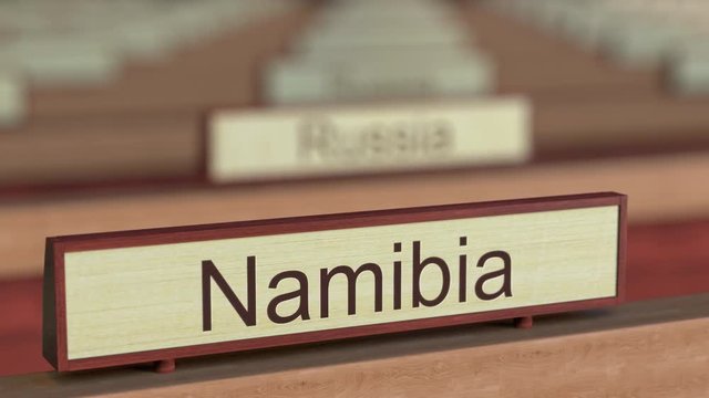 Namibia name sign among different countries plaques at international organization. 3D rendering