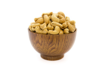 Cashew nuts in wooden bowl isolated on white background. Concept food image