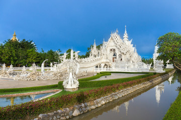 Wat Rong Khun The White Abstract Temple and pond with fish, in Chiang Rai, Thailand. Popular and famous in vacation for tourist.