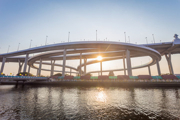 Fototapeta premium Modern concrete bridges the ways across big river in sunset time with sunlight.