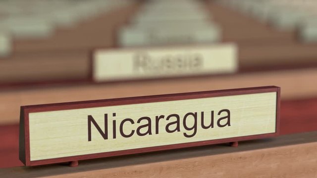 Nicaragua name sign among different countries plaques at international organization. 3D rendering