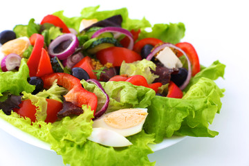 salad from fresh vegetables in a plate on a table, selective focus