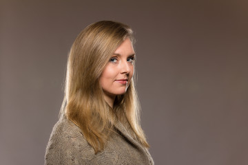 Young caucasian woman headshot against light background