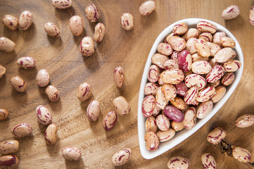 Pinto beans on wood bowl