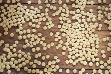 Raw lentils on wooden table - Lens culinaris