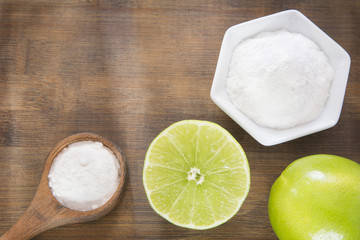 Baking soda and lemon on wooden table