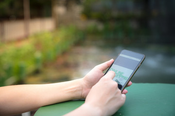 Business Woman use Smart Phone to  Shopping Online in the Garden on Backyard her Home