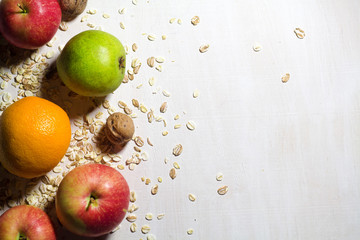Pear, apple and nutsleaves on the white wooden table
