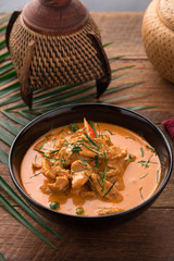 Red Curry with pork on wooden table, Thai food.