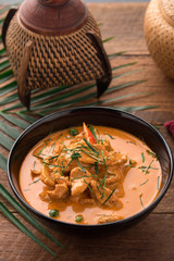 Red Curry with pork on wooden table, Thai food.