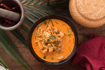 Red Curry with pork on wooden table, Thai food.