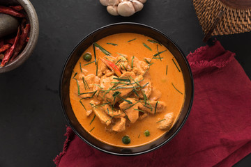 Red Curry with pork on wooden table, Thai food.