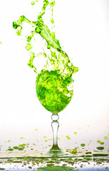 green wine splash in the glass on white background,green water drop splash on white background